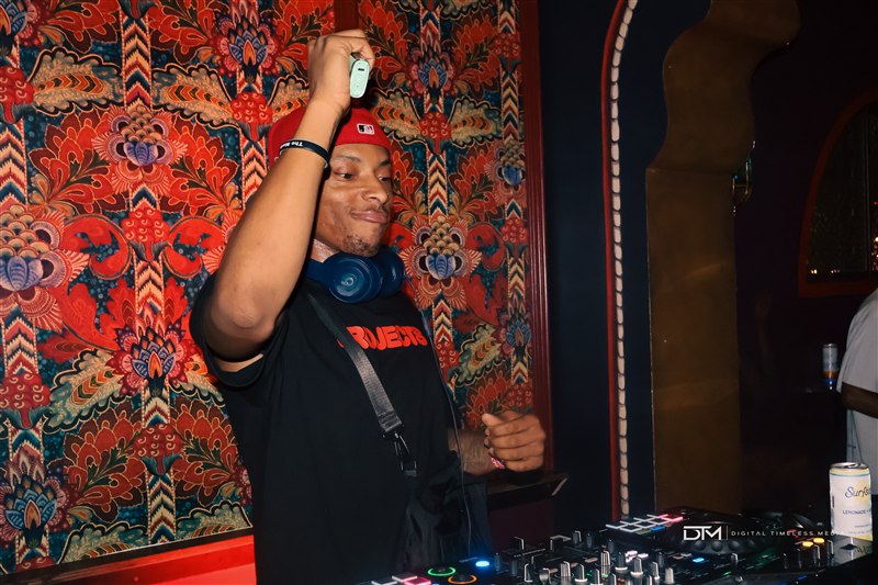 DJ raising a hand during a set